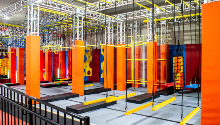 Brightly coloured interior ninja warrior parkour gym obstacle co